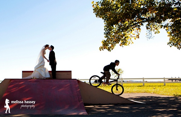Picture of a bride and groom kissing on top of a BMX ramp by Melissa Hassey Photography