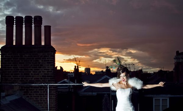Picture of Bride leaning back on a rail with the night sky behind her by Sean Casey Photography