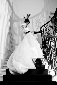 Black and white picture of a bride walking up the stairs by Sean Casey Photography