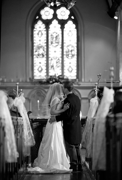 Bride and groom kissing at the altar - Picture by Rusty and Sailor Photography
