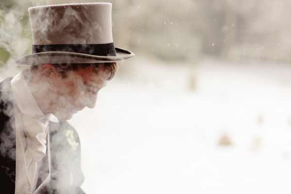 Groomsman wearing top hat surrounded by smoke - Picture by Kathryn Edwards Photography