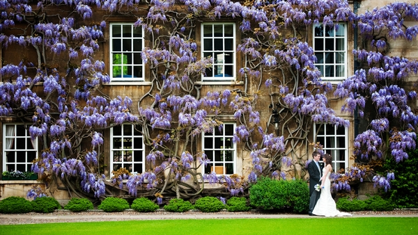 Bride and groom standing in front of a grand wedding venue - Picture byMcAvoy Photography